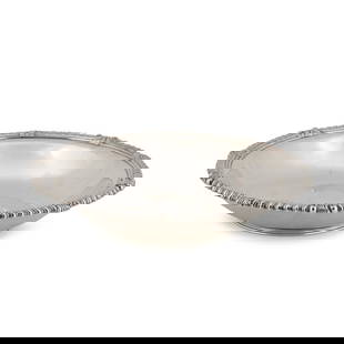 A Tiffany & Co. Sterling Silver Bowl,: A Tiffany & Co. Sterling Silver Bowl, New York, 1907-1938, of compressed form, the slightly flared rim with gadrooning intersected by palmettes, raised on a circular spreading foot, dia. 9 in.,