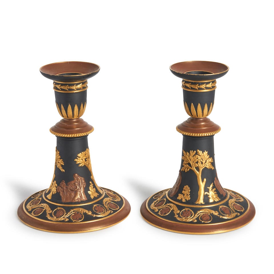 Pair of Wedgwood Bronze and Gilt Black Basalt Candsticks, England, c. 1885,: Pair of Wedgwood Bronze and Gilt Black Basalt Candsticks, England, c. 1885, each nozzle with stiff leaves above a beaded border with classical figures below, an arabesque floral band to foot, impresse