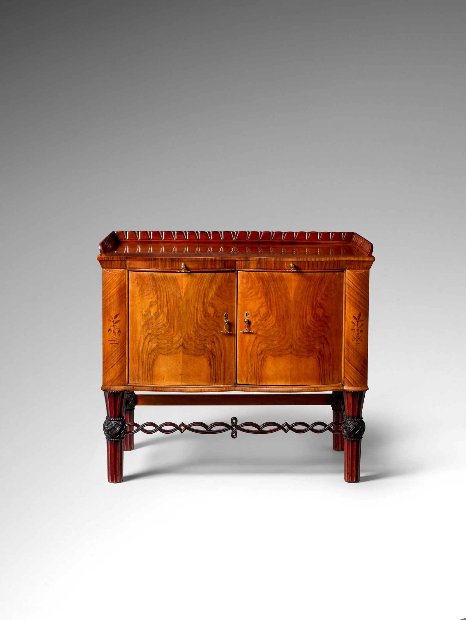 OTTO PRUTSCHER (1880-1949) Two-Door Cabinet1924for Anton Popischil, solid, carved, and inlaid w...: OTTO PRUTSCHER (1880-1949) Two-Door Cabinet 1924 for Anton Popischil, solid, carved, and inlaid walnut, brass pulls, metal manufacturer's label to the inside door height 37 1/4in (94.5cm); width 43 1/