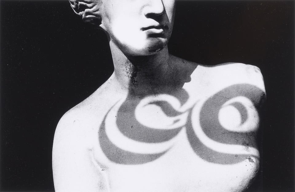Ralph Gibson (born 1939); Untitled (Statue with Reflected Shadow);: Ralph Gibson (born 1939) Untitled (Statue with Reflected Shadow), 1975 Gelatin silver print, printed later; signed and dated in pencil on the reverse. 8 x 12 1/2 in. (20.3 x 31.6 cm.) sheet 11 x 14 in