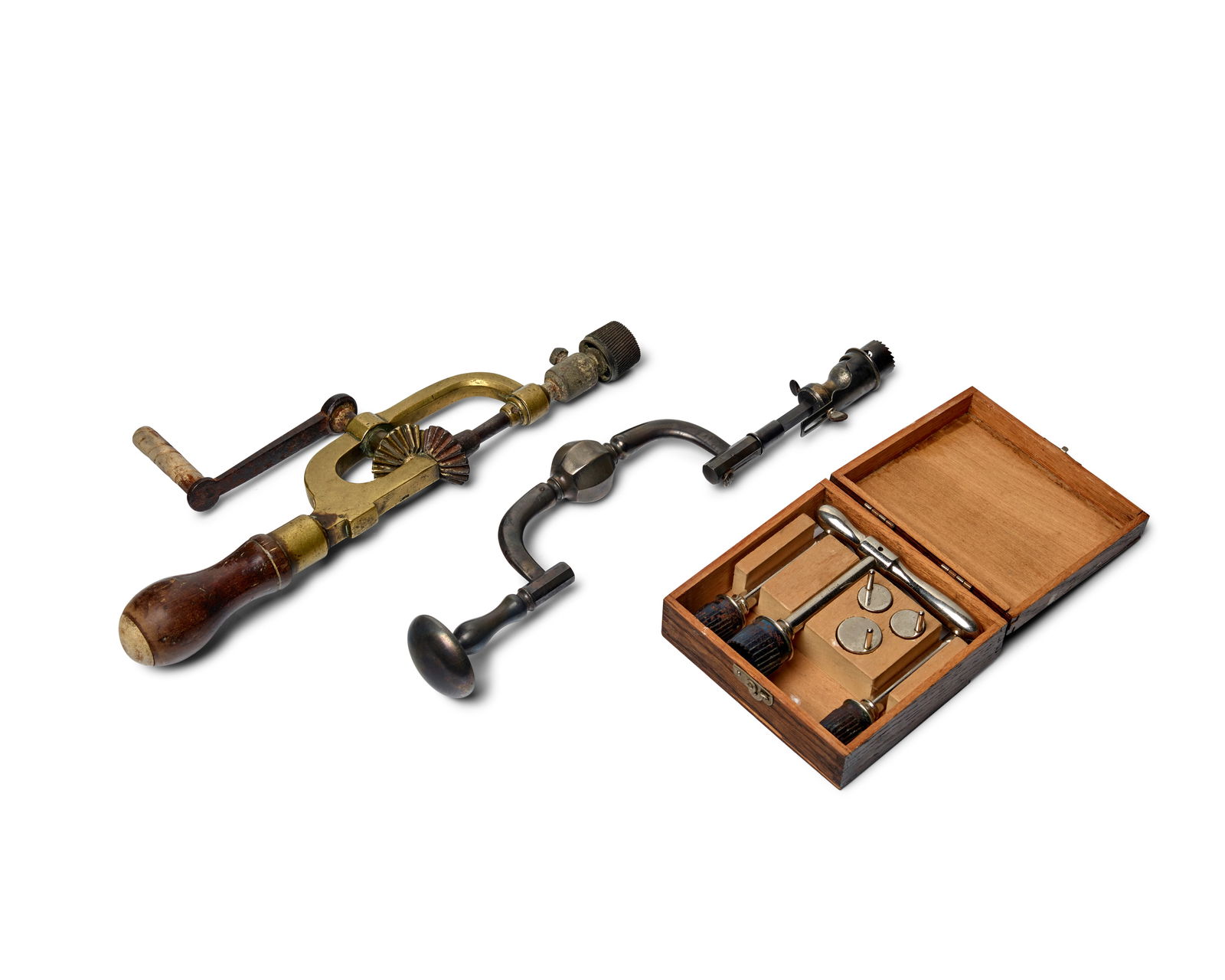 MEDICAL INSTRUMENTS: TREPANATION. Collection of 3 instruments:: MEDICAL INSTRUMENTS: TREPANATION. Collection of 3 instruments: 1. Trephine brace, Collin, Paris, mid-19th century, 314 mm long, some corrosion. 2. Trephine brace, brass and wood with bone handle and e