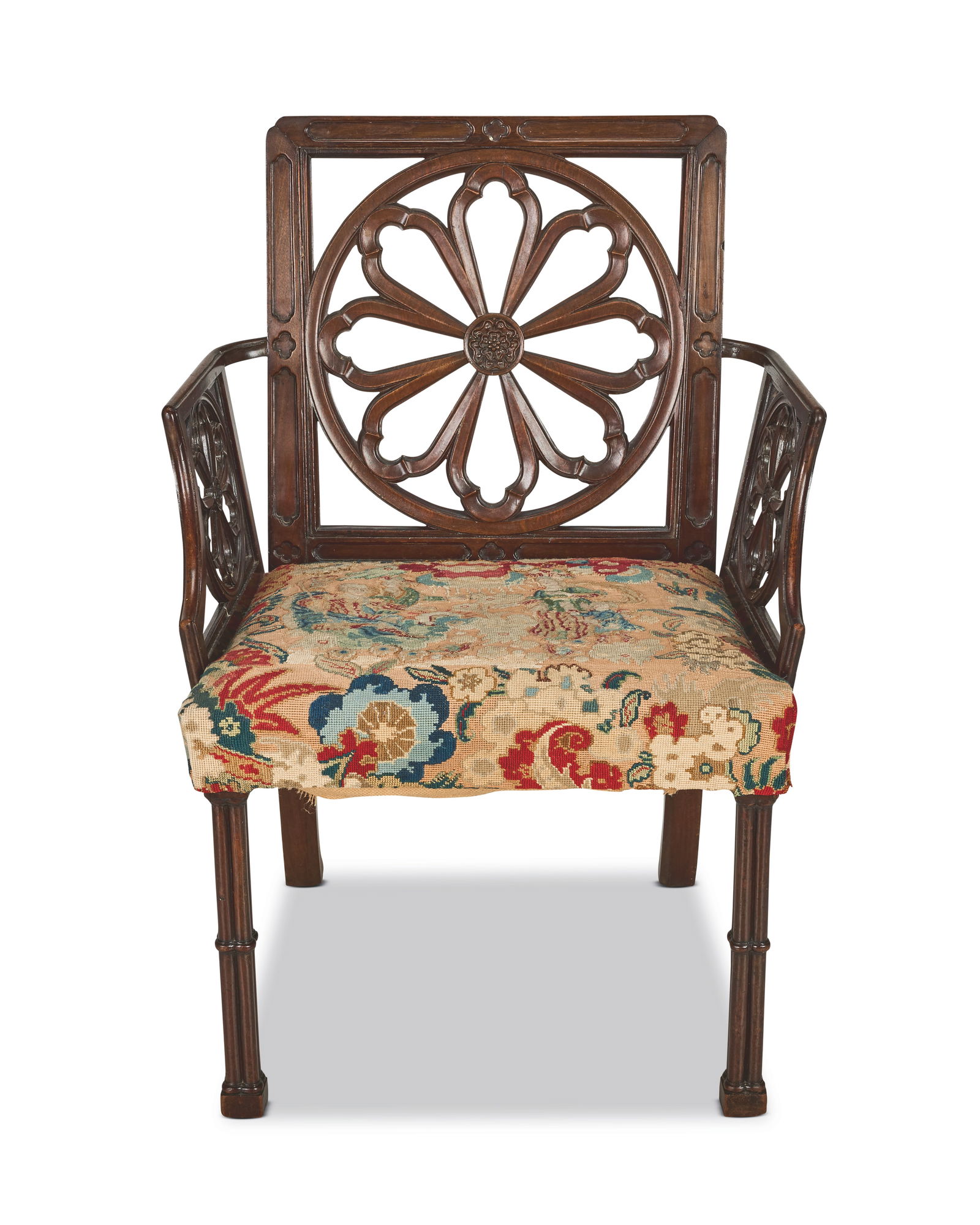 A George III 'Gothick' mahogany open armchair After designs by Robert Manwaring and certainly in...: A George III 'Gothick' mahogany open armchair After designs by Robert Manwaring and certainly influenced by a Thomas Chippendale design, with restorations The square back with re-entrant upper angles