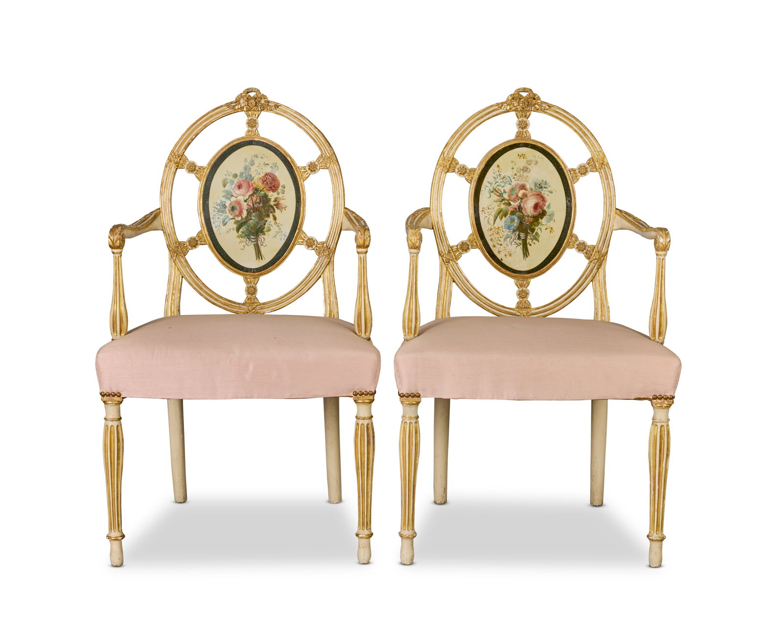 A pair of George III cream painted, polychrome decorated and parcel gilt open armchairs attribut...: A pair of George III cream painted, polychrome decorated and parcel gilt open armchairs attributed to George Brookshaw (1751-1823) Circa 1780 Each with an oval medallion back comprised of a copper pan