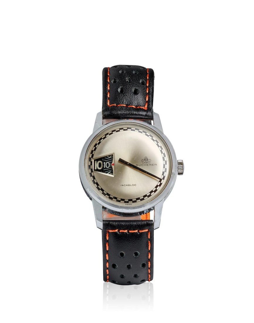 [NO RESERVE] BUCHERER. A STAINLESS STEEL MANUAL WIND JUMP HOUR WRISTWATCHc. 1970s: [NO RESERVE] BUCHERER. A STAINLESS STEEL MANUAL WIND JUMP HOUR WRISTWATCH Date: c. 1970s Movement: 17-jewel manual wind Dial: Silvered Case: Round, screw down case back Strap/Bracelet: Black leather B