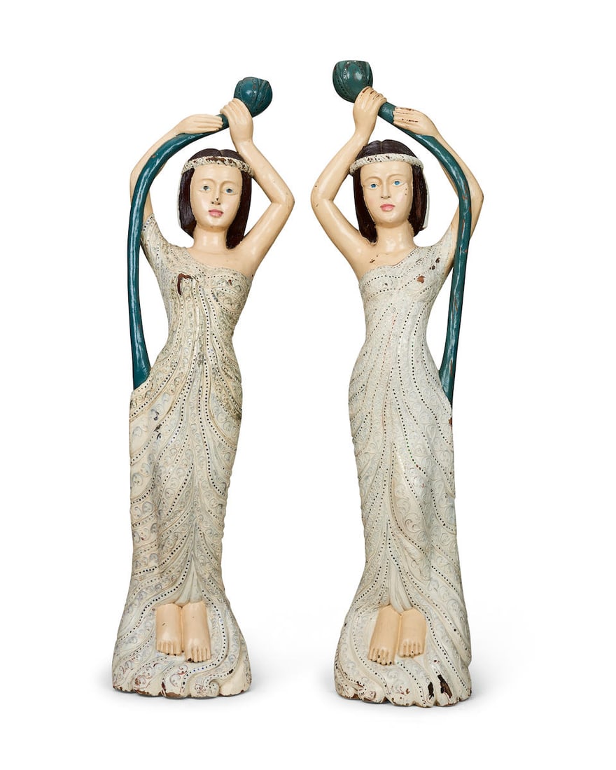 A pair of carved and painted organ figures of female figures Possibly Italian, circa 1910 (2): A pair of carved and painted organ figures of female figures Possibly Italian, circa 1910 The ladies holding aloft lotus flowers, wearing dresses profusely decorated with scrolling fronds and adorned
