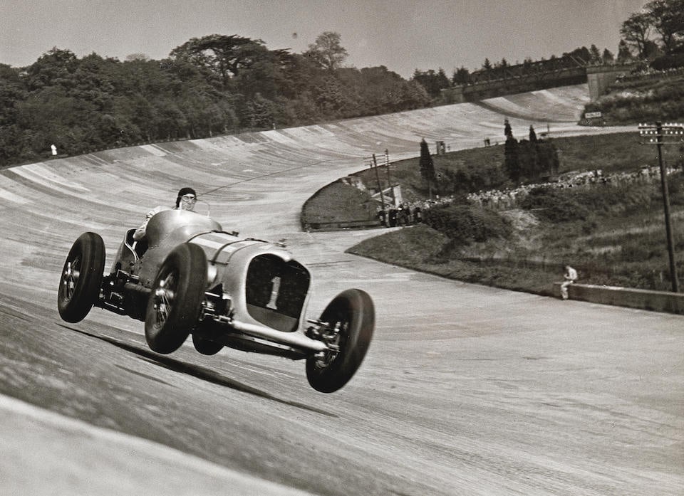 John Cobb - Napier Railton, limited print 02/25 monochrome photograph by Jarrotts,: John Cobb - Napier Railton, limited print 02/25 monochrome photograph by Jarrotts, depicting the 'Outright and everlasting lap record 143.44mph at Brooklands in 1937', 12 x 16, mounted, framed and gla