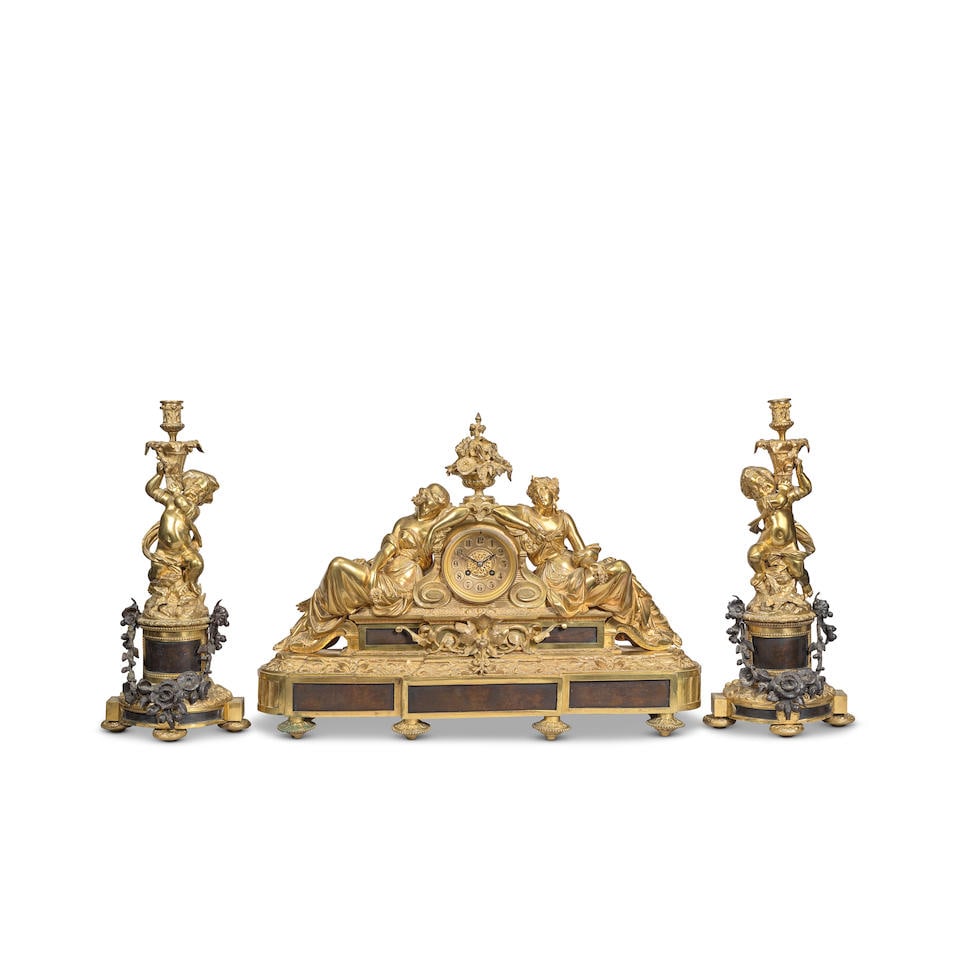An impressive late 19th century gilt and patinated bronze French figural mantle clock together w...: An impressive late 19th century gilt and patinated bronze French figural mantle clock together with a pair of associated figural candlestick garniture The clock dial signed Sir John Bennett Ltd, Paris