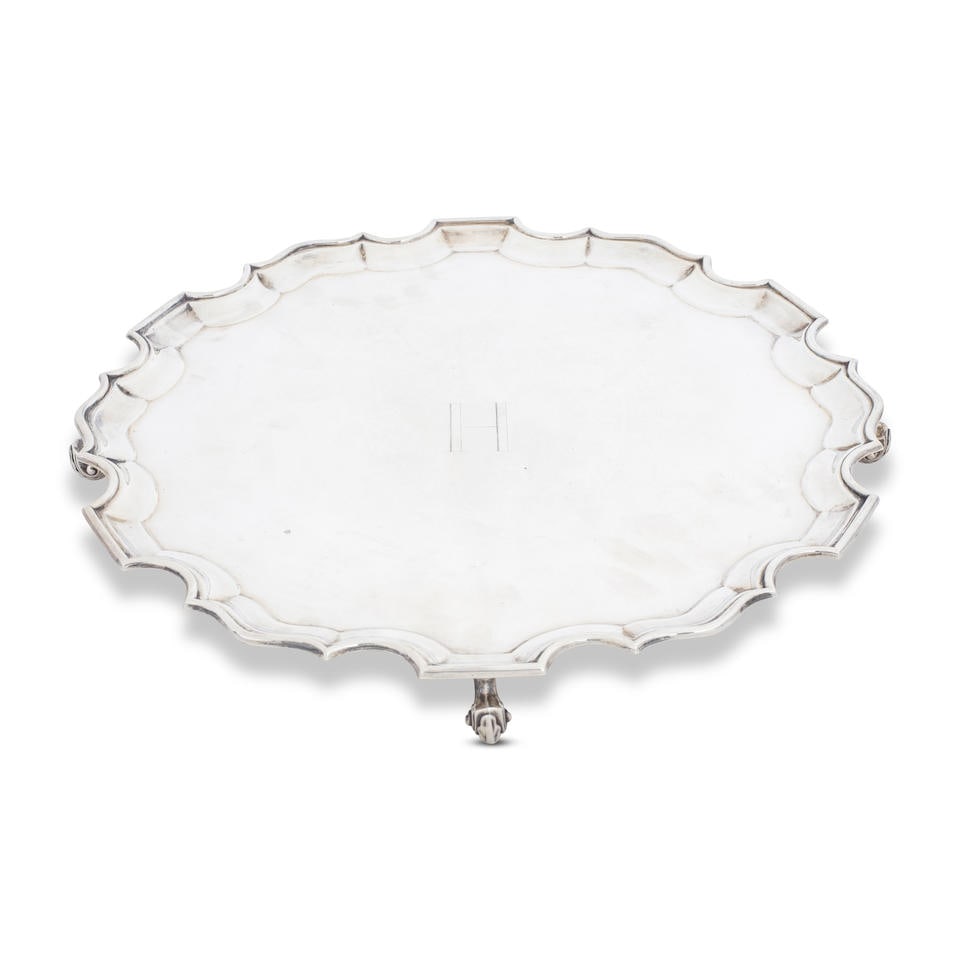 A silver salver Fordham & Fordham, Sheffield 1922: A silver salver Fordham & Fordham, Sheffield 1922 Shaped-circular on three leaf scroll feet, centre engraved with initial 'H', diameter 36cm, weight 44oz. For further information on this lot please v