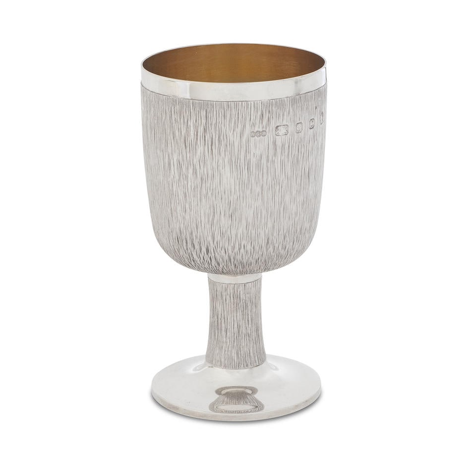 GERALD BENNEY: a large silver goblet London 1977: GERALD BENNEY: a large silver goblet London 1977 With a narrow polished rim, tapering bowl with bark-effect textured sides which curves under the lower body, bark-effect texture on slightly concave st