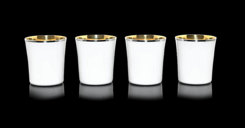 GERALD BENNEY: a set of four silver and white enamelled beakers London 1973, with master enamell...: GERALD BENNEY: a set of four silver and white enamelled beakers London 1973, with master enamellers mark AAE for Alan Alfred Evans underside of bases incuse stamped GERALD BENNEY LONDON Slightly flare