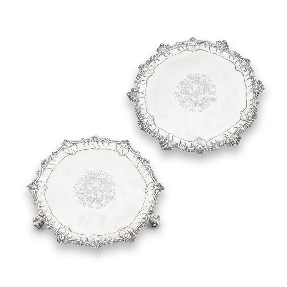 Two George III silver salvers John Swift, London 1761 (2): Two George III silver salvers John Swift, London 1761 Similar in design, shaped-circular, shell and scroll gadroon rim, both engraved with the same armorial engraving, one on spreading scroll feet, t