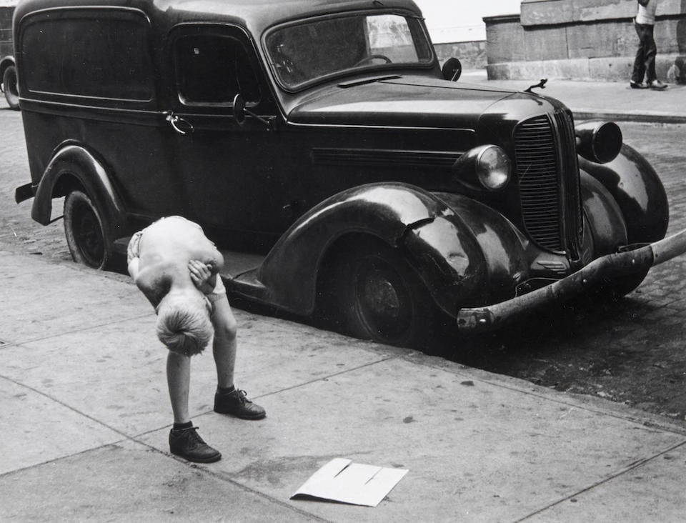 Helen Levitt (1918-2009); N.Y. (boy looking under car);: Helen Levitt (1918-2009) N.Y. (boy looking under car), c. 1942 Gelatin silver print; titled and signed 'Helen Levitt' in pencil on the verso. 7 1/8 x 9 1/4 in. (18.2 x 23.5 cm) sheet 10 7/8 x 13 7/8 i