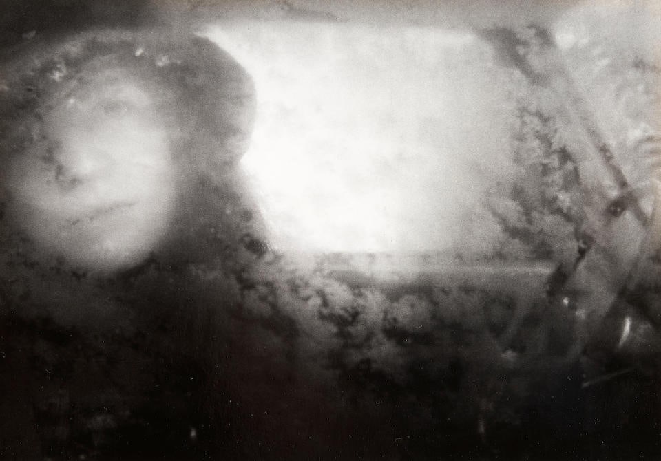 Nicholas Nixon (born 1947); Untitled (Bebe through Window);: Nicholas Nixon (born 1947) Untitled (Bebe through Window), 1971 Gelatin silver print; signed 'Nicholas Nixon 1971' on the overmat; mounted and matted. 6 1/16 x 8 11/16 in. (15.4 x 22.1 cm) mount 14 1/