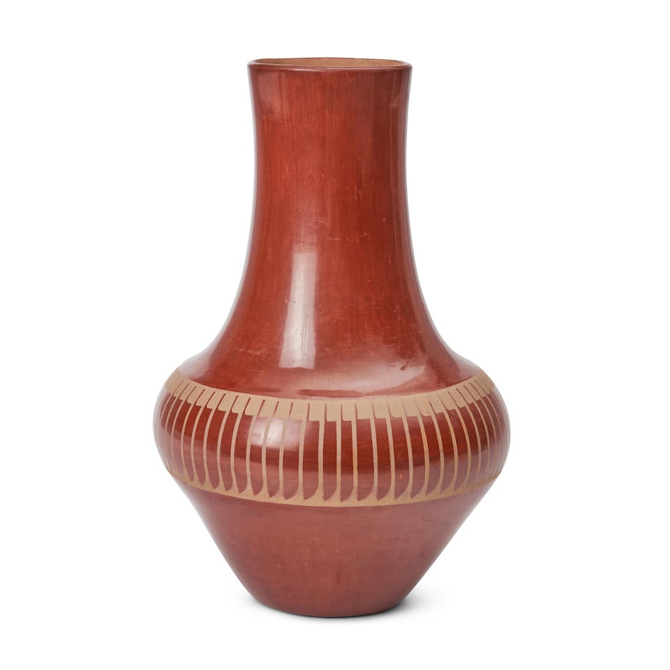 A Maria Martinez and Popovi Da redware jar Maria Martinez and Popovi Da San Ildefonso, (1887-198...: A Maria Martinez and Popovi Da redware jar Maria Martinez and Popovi Da San Ildefonso, (1887-1980) & (1922-1971) A tall redware jar designed with a buff feather collar below the tall flaring neck, sig