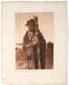 Edward S. Curtis (1868-1952) Hamasaka in Tlu'wulahu costume with speaker's staff and Qagyuhl vil...
