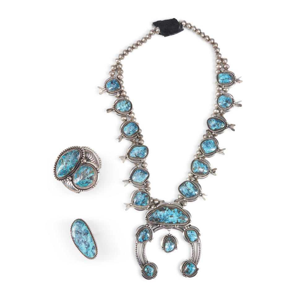 A suite of turquoise and silver jewelry lg. of necklace 31, lg. of naja 4, gross weight approxim...: A suite of turquoise and silver jewelry Including a a squash blossom necklace, with twelve squash pendants, each with a single turquoise setting, the three-wire naja with six settings, (traces of hard