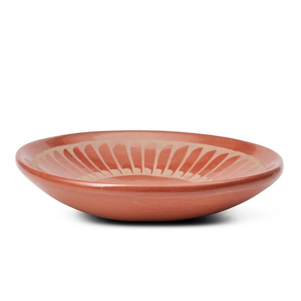 A Santana and Adam Martinez redware plate Santana and Adam Martinez, San Ildefonso Pueblo, (1909...: A Santana and Adam Martinez redware plate Santana and Adam Martinez, San Ildefonso Pueblo, (1909-2002) and (1903-2000) Rendered with a repeated feather pattern, with open center, signed 'Santana and A