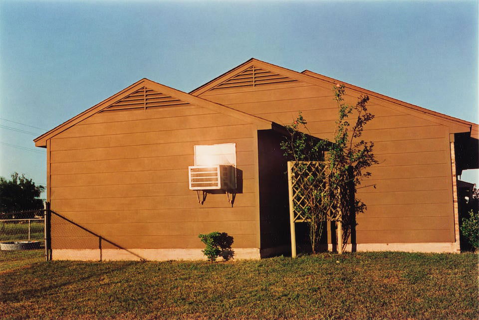 William Eggleston (born 1939); Untitled (Brown House in Sunshine) (from 'Dust Bells Volume II');: William Eggleston (born 1939) Untitled (Brown House in Sunshine) (from 'Dust Bells Volume II'), 1971-74 Dye-transfer print, printed 2004; signed in ink in the margin, the photographer's printing infor