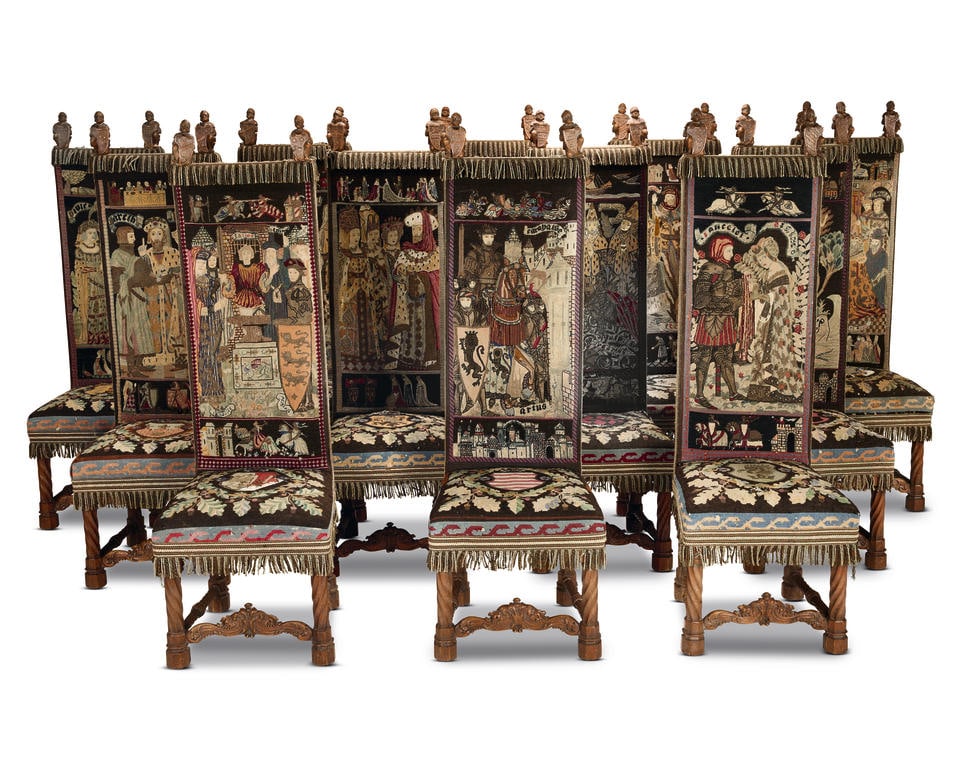 A rare set of thirteen Edwardian or George V 'Antiquarian' chairs in the Norman or early Gothic ...: A rare set of thirteen Edwardian or George V 'Antiquarian' chairs in the Norman or early Gothic style upholstered with needleworks depicting scenes based upon the legends of King Arthur Together with