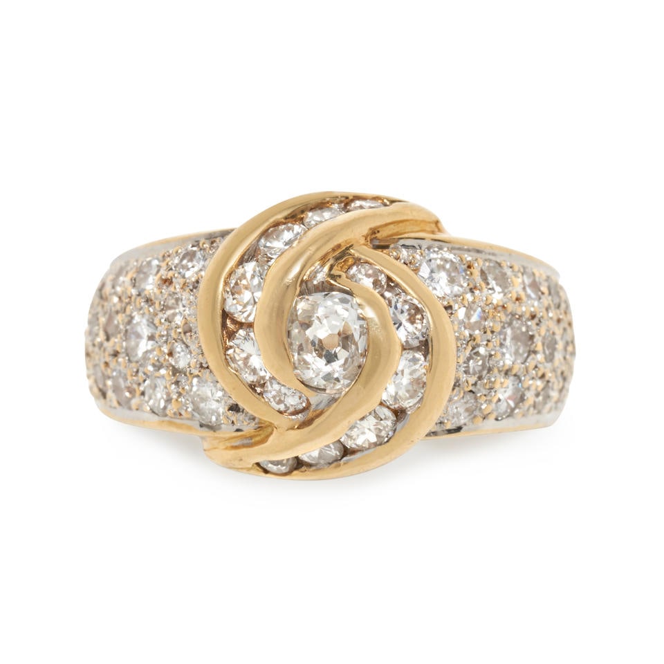 AN 18K GOLD AND DIAMOND RING: AN 18K GOLD AND DIAMOND RING Centering an old mine-cut diamond, framed by full, old European, and single-cut diamond swirl, and further set with pavé full and single-cut diamonds, approximate tot