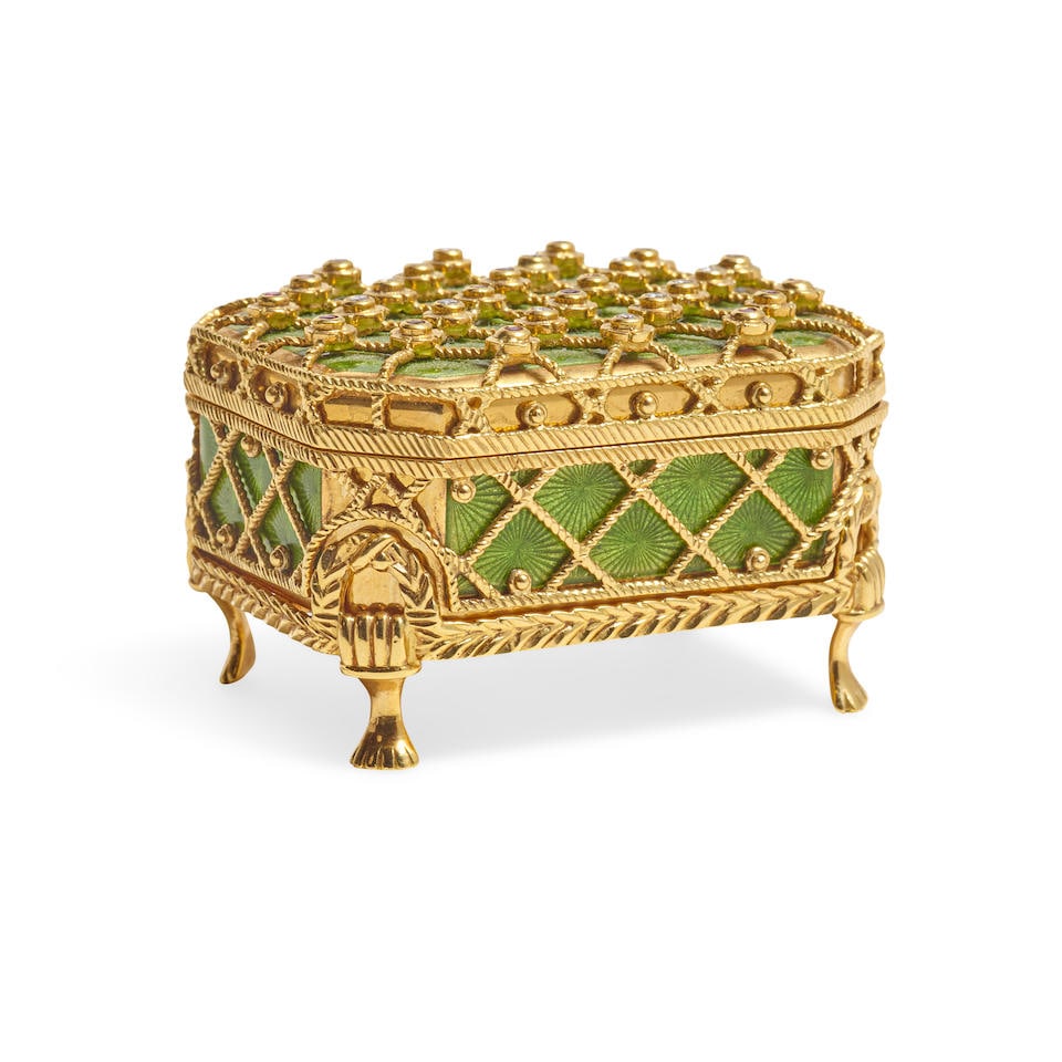 A FABERGÉ GEMSTONE INSET 18K GOLD AND GREEN GUILLOCHÉ ENAMEL HINGED PILL BOX ON FOOTED...: A FABERGÉ GEMSTONE INSET 18K GOLD AND GREEN GUILLOCHÉ ENAMEL HINGED PILL BOX ON FOOTED STAND Victor Mayer, 20th century The box overlaid with rope twist trellising mounted with diamonds and