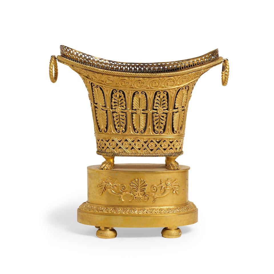 AN EMPIRE GILT BRONZE JARDINIÈRECirca 1810: AN EMPIRE GILT BRONZE JARDINIÈRE Circa 1810 With a gilt metal liner. height 10 1/2in (26.5cm); width 10in (25.4cm) Footnotes: Provenance Daatselaar & Godhelp Antiquairs, no. 6946; Acquired from t