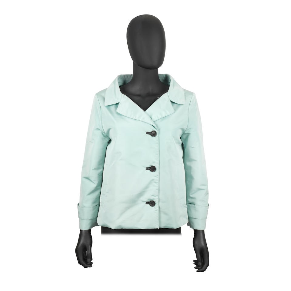 Prada: a Duck Egg Blue Padded Short Jacket 1990s: Prada: a Duck Egg Blue Padded Short Jacket 1990s Button up closure Labelled size S Footnotes: CONDITION REPORT Condition Grade B- Appears in a good pre-loved vintage condition, with signs of use. Smal