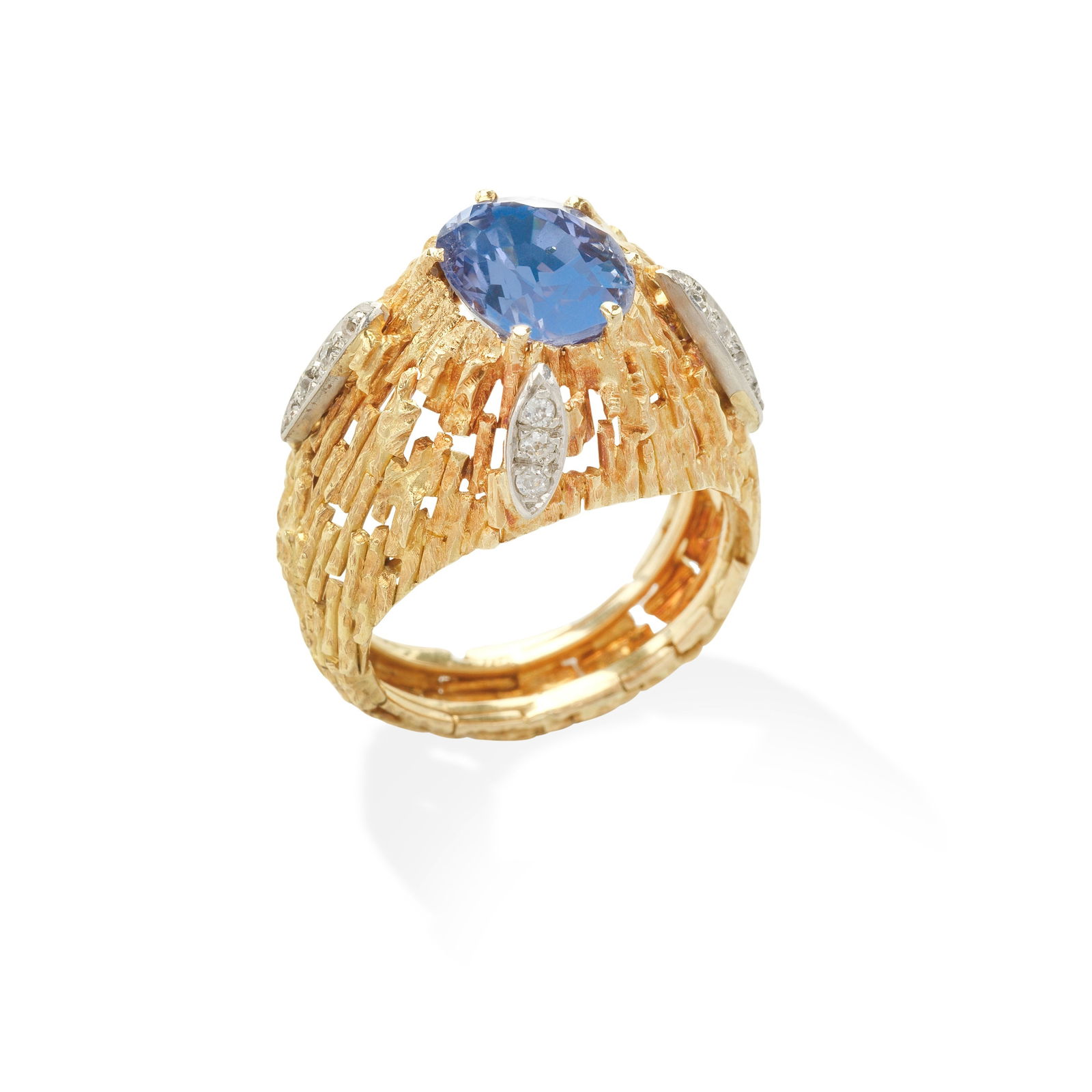 GRIMA: SAPPHIRE AND DIAMOND RING,: GRIMA: SAPPHIRE AND DIAMOND RING, CIRCA 1965 The oval-cut sapphire within a pierced and textured bombé mount, accented by cushion-shaped diamonds, signed Grima, HJCo (obscured), sapphire a later
