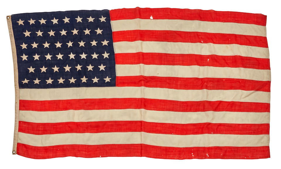 A 46 STAR 1908 AMERICAN FLAG. Canton of 46 stars against blue, field of 13 alternating red and w...: A 46 STAR 1908 AMERICAN FLAG. Canton of 46 stars against blue, field of 13 alternating red and white stripes, by Annin & Co., [1908], approximately 40 x 70 inches (1,015 x 1,778 mm), pieced linen bunt