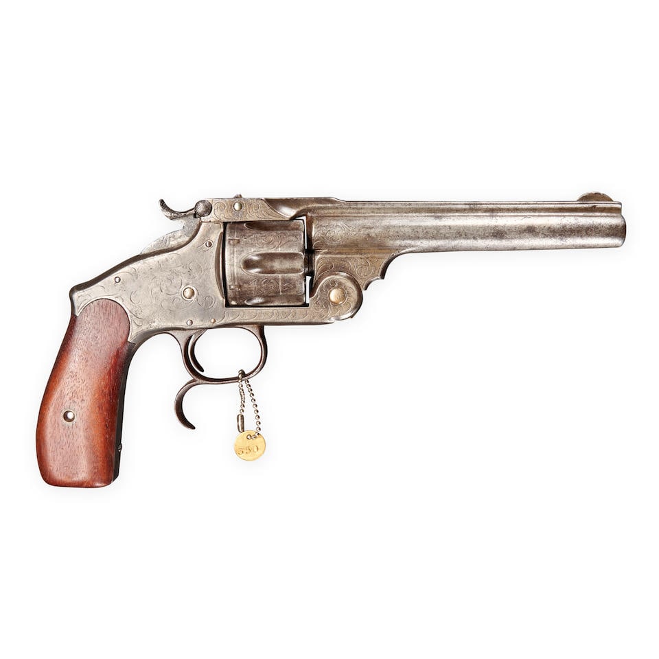 A SMITH & WESSON RUSSIAN STYLE REVOLVER,: A SMITH & WESSON RUSSIAN STYLE REVOLVER, c. 1870s. Serial number 8661, .44 caliber, the top of the barrel marked 'SPRING HEAD VK NEW YORK'; frame with foliate scroll engraving, walnut grip. Barrel lg.