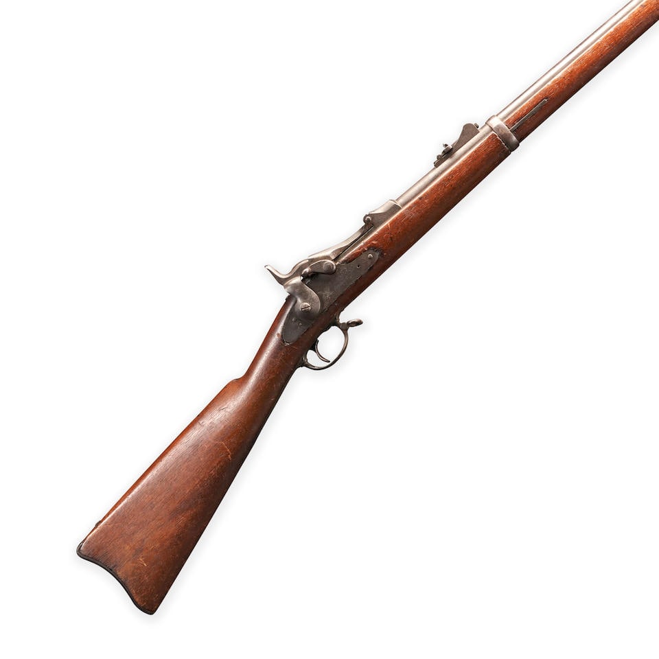 A SPRINGFIELD U.S. MODEL 1884 TRAPDOOR RIFLE,: A SPRINGFIELD U.S. MODEL 1884 TRAPDOOR RIFLE, 1883. Serial number 217106, .45-70 caliber, round barrel with 'V', 'P' and eagle proof marks at the breech, the loading door marked 'U.S./MODEL/1884'; fla