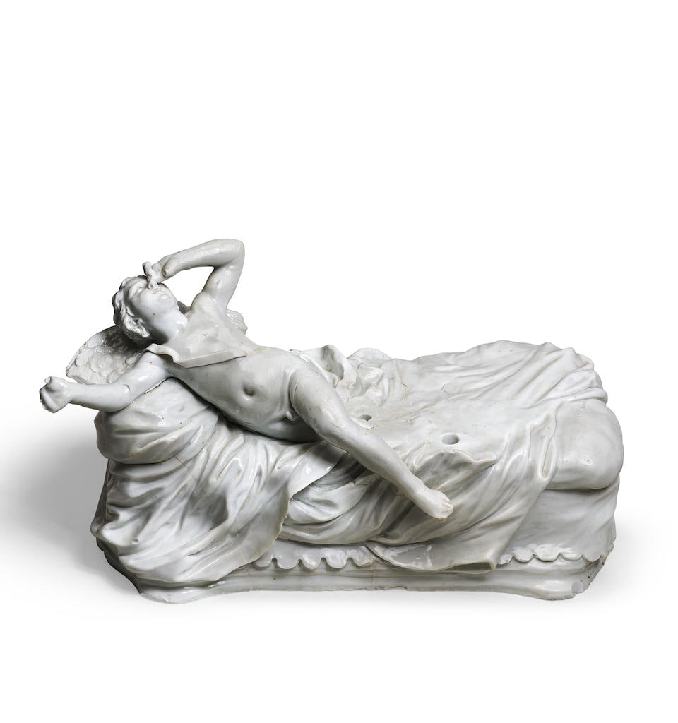 A Doccia group of Cupid and Psyche, circa 1750: A Doccia group of Cupid and Psyche, circa 1750 After the model by Giovanni Battista Foggini, the reclining Cupid stretching out his right arm, his leg just stretching over the edge of the bed, leaning
