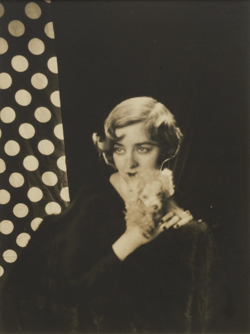 Cecil Beaton (1904-1980); Nancy Cunard with Dog;: Cecil Beaton (1904-1980) Nancy Cunard with Dog, c. 1927 Gelatin silver print; mounted, signed in red ink on the mount, framed. 12 3/8 x 9 1/4 in. (31.4 x 23.5 cm.) mount 16 x 12 in. (40.6 x 30.5 cm.)