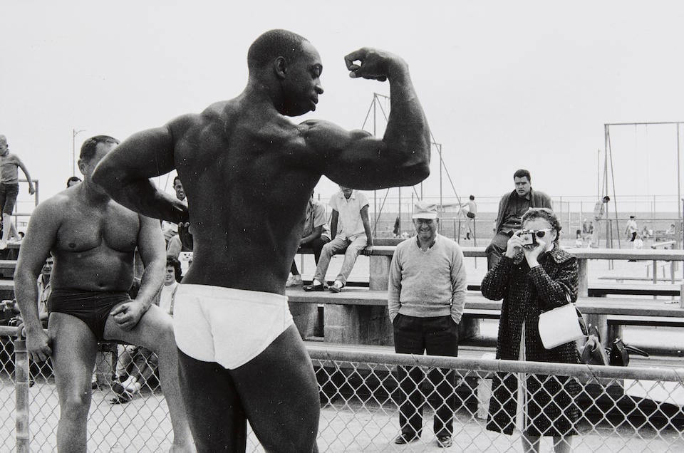 Bruce Davidson (born 1933); Muscle Beach, Los Angeles;: Bruce Davidson (born 1933) Muscle Beach, Los Angeles, 1964 Gelatin silver print, printed later; signed in pencil on the reverse. 8 3/8 x 12 7/8 in. (21.2 x 32.7 cm.) sheet 11 x 14 in. (28 x 35.6 cm.)