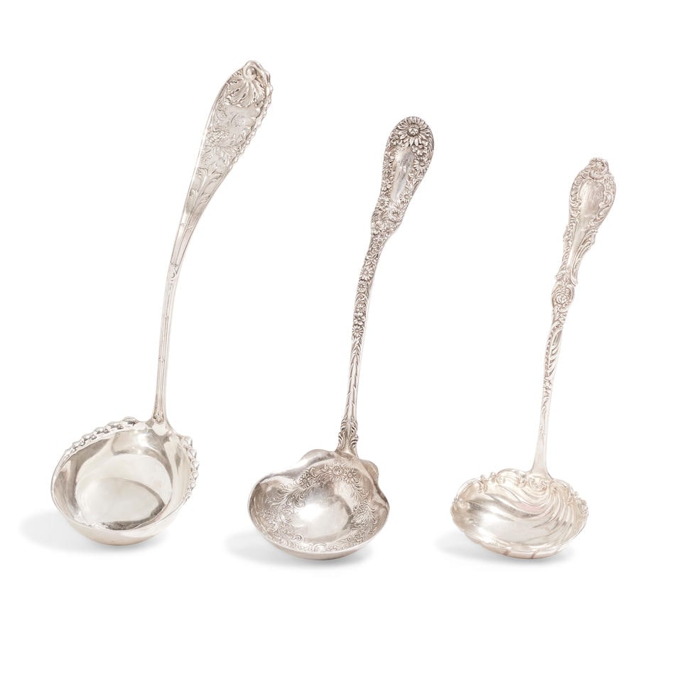 THREE AMERICAN STERLING SILVER LADLES by various makers, late 19th/early 20th century: THREE AMERICAN STERLING SILVER LADLES by various makers, late 19th/early 20th century Comprising a Wood & Hughes Undine cream ladle with engraved monogram, length 13in (33cm), a Frank Smith Silver Co.
