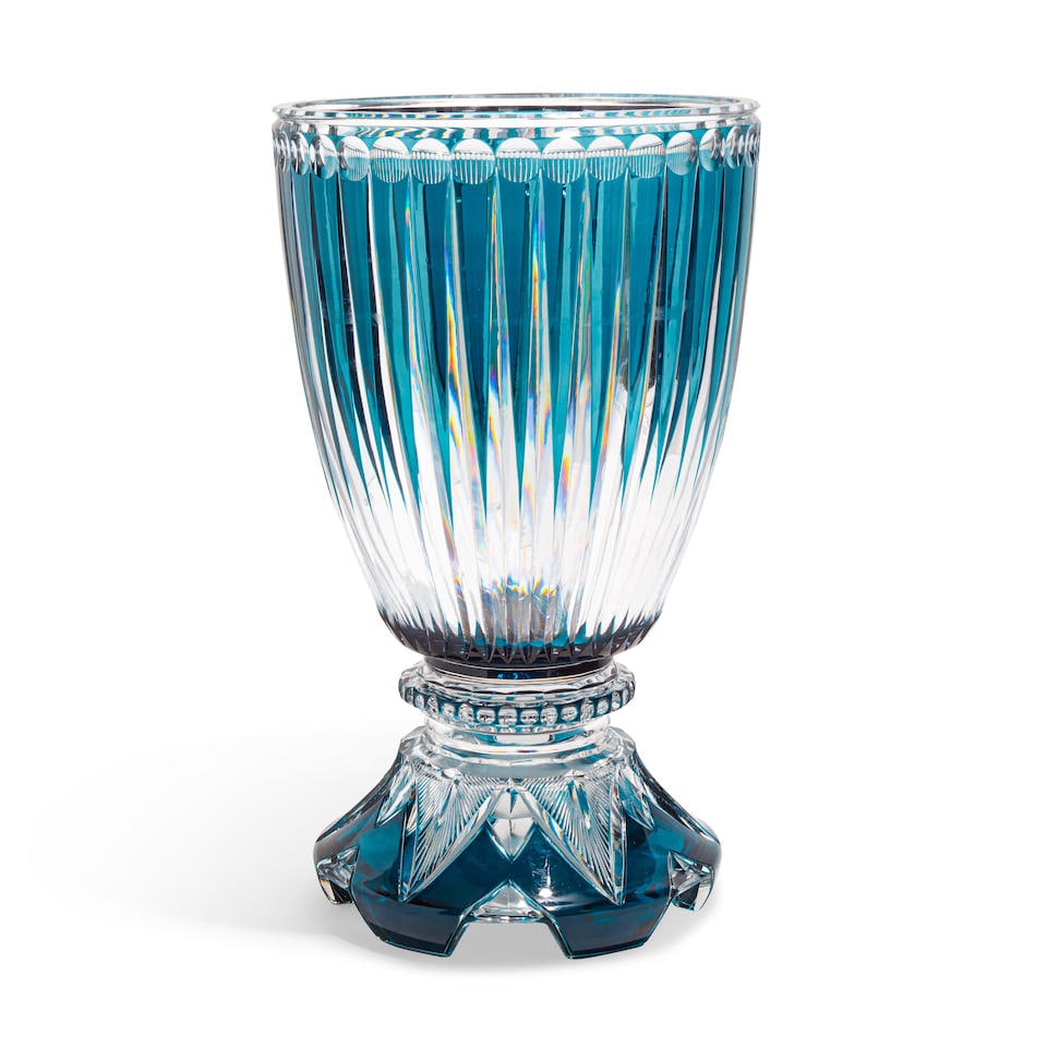 A COLORLESS AND BLUE CUT-GLASS CENTERPIECE: A COLORLESS AND BLUE CUT-GLASS CENTERPIECE height 18 1/2in (47cm); diameter 11in (28cm) Footnotes: From a Donna Livingston designed Wilshire penthouse. Condition reports are not provided in catalog de
