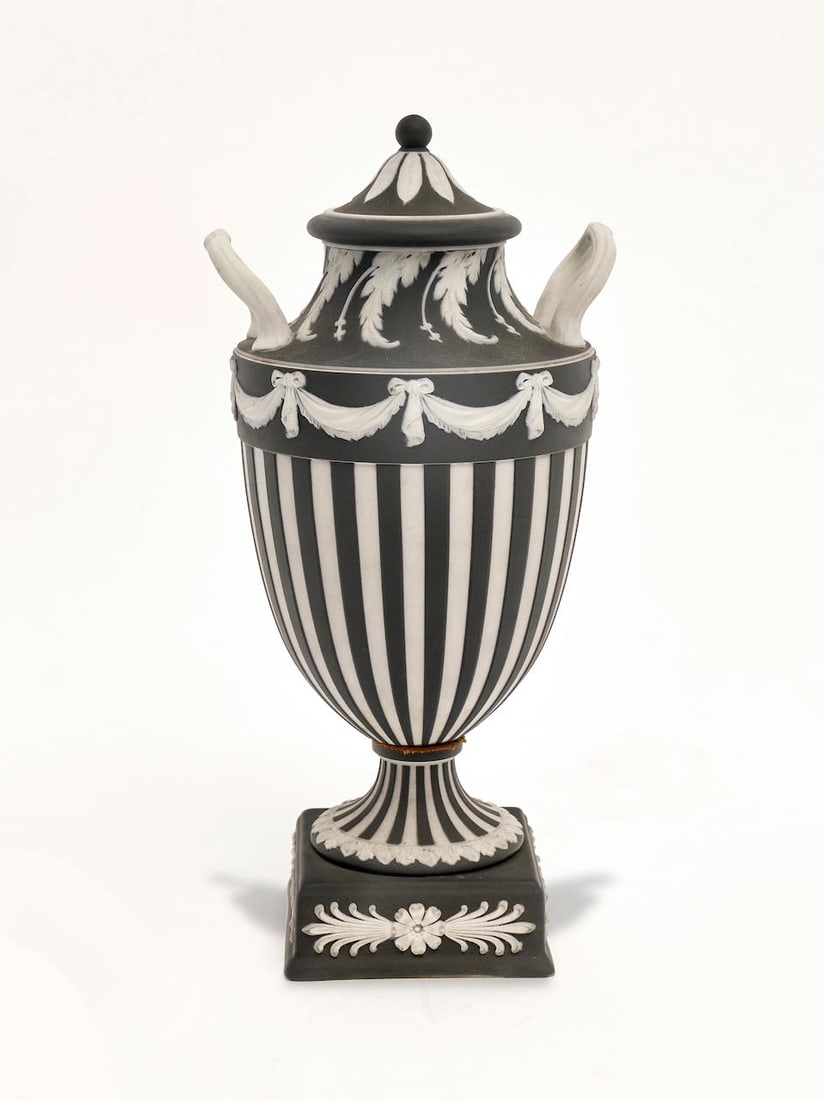 A Wedgwood Jasperware urn and cover 27.0cm high: A Wedgwood Jasperware urn and cover Of campana form, marked to base: 'WEDGWOOD MADE IN ENGLAND 8' 27.0cm high For further information on this lot please visit Bonhams.com For further information about