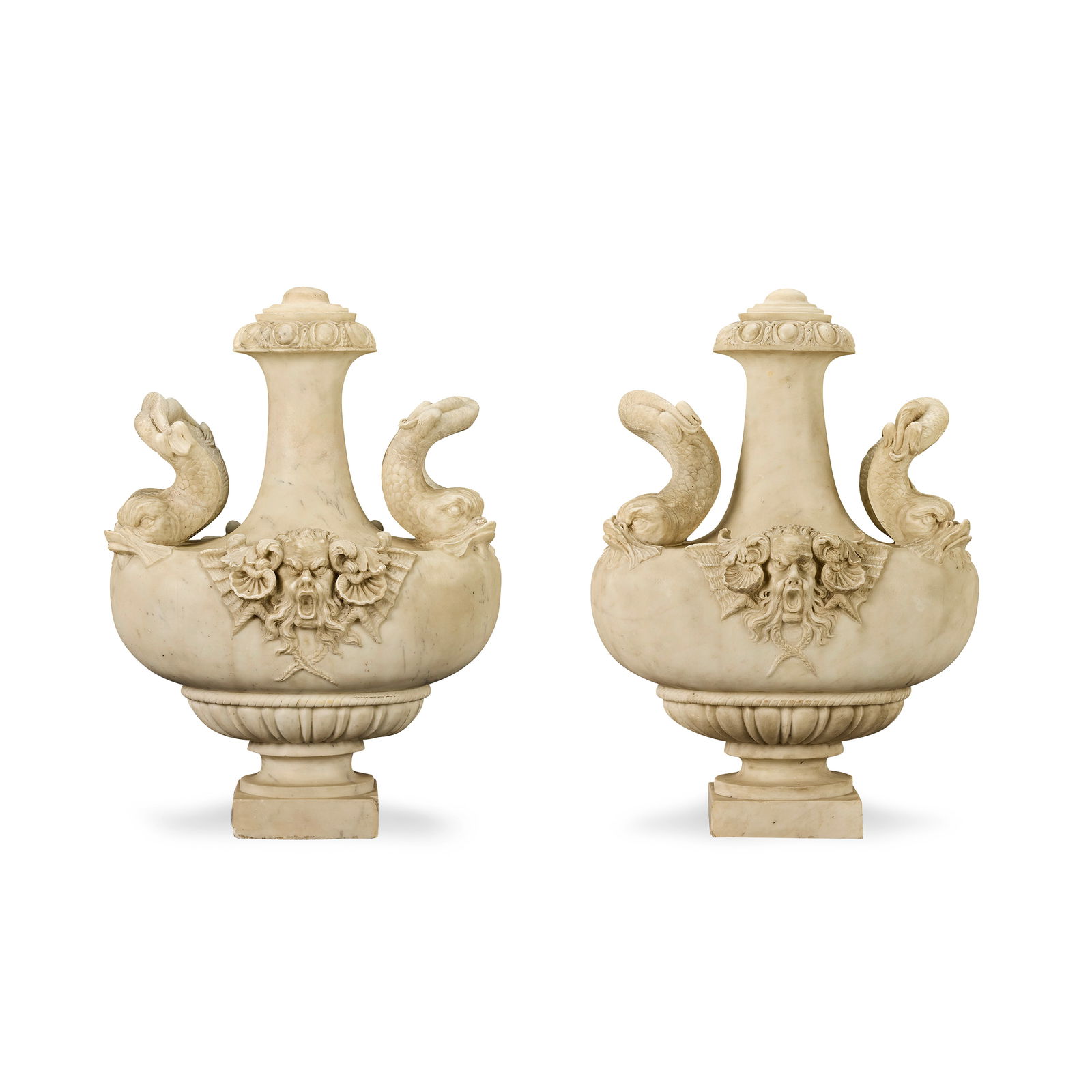 Circle of Giovanni Battista Foggini (Italian, 1652-1725): A near pair of impressive carved marbl...: Circle of Giovanni Battista Foggini (Italian, 1652-1725): A near pair of impressive carved marble urns Probably early 18th century The slender tapering waisted necks with ovolo and acanthus moulded co