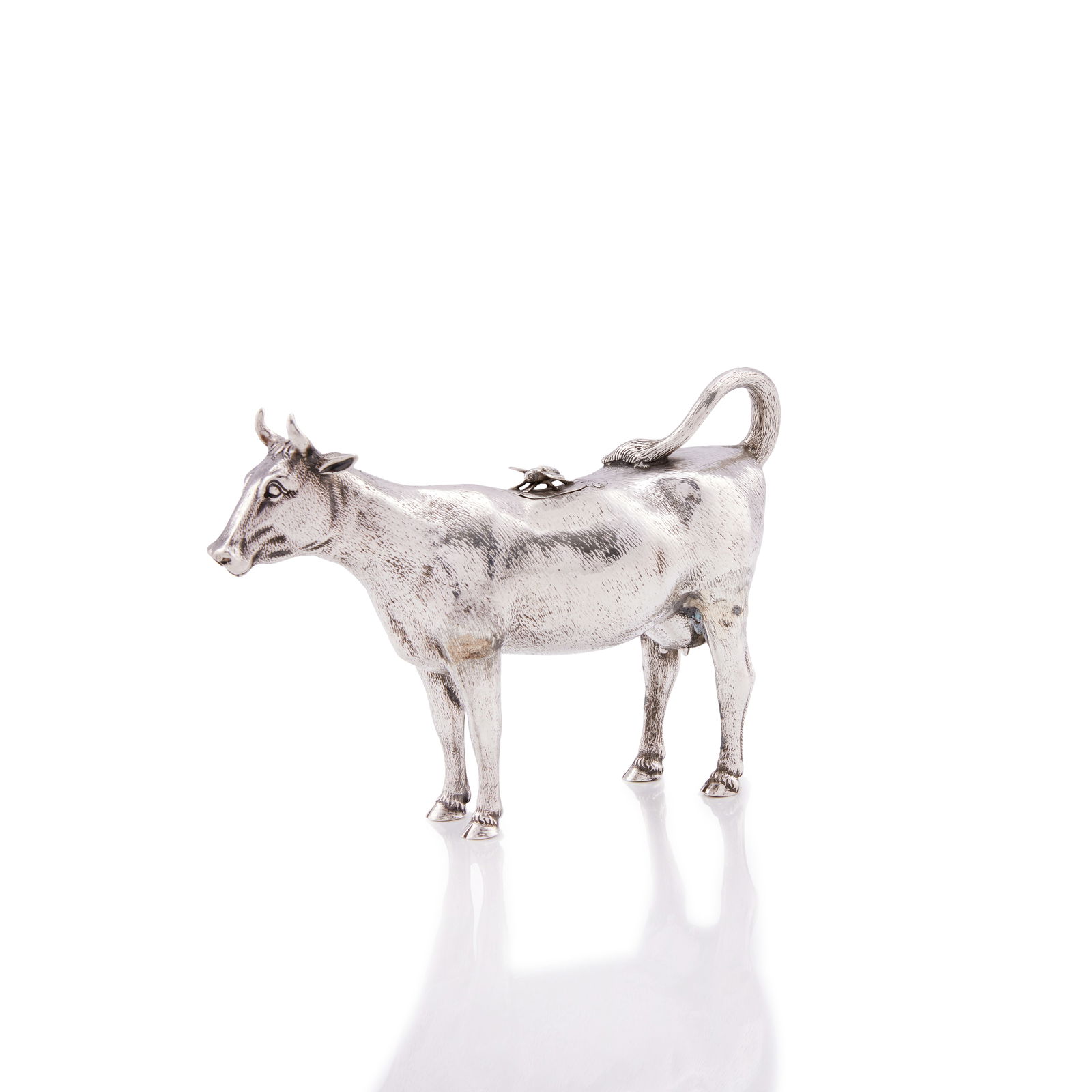 A fine Victorian silver cow creamer George Fox, London 1875: A fine Victorian silver cow creamer George Fox, London 1875 Naturalistically modelled as a standing cow, with hair effect chasing, the hinged cover with applied fly finial, height 11.5cm, length 16cm,