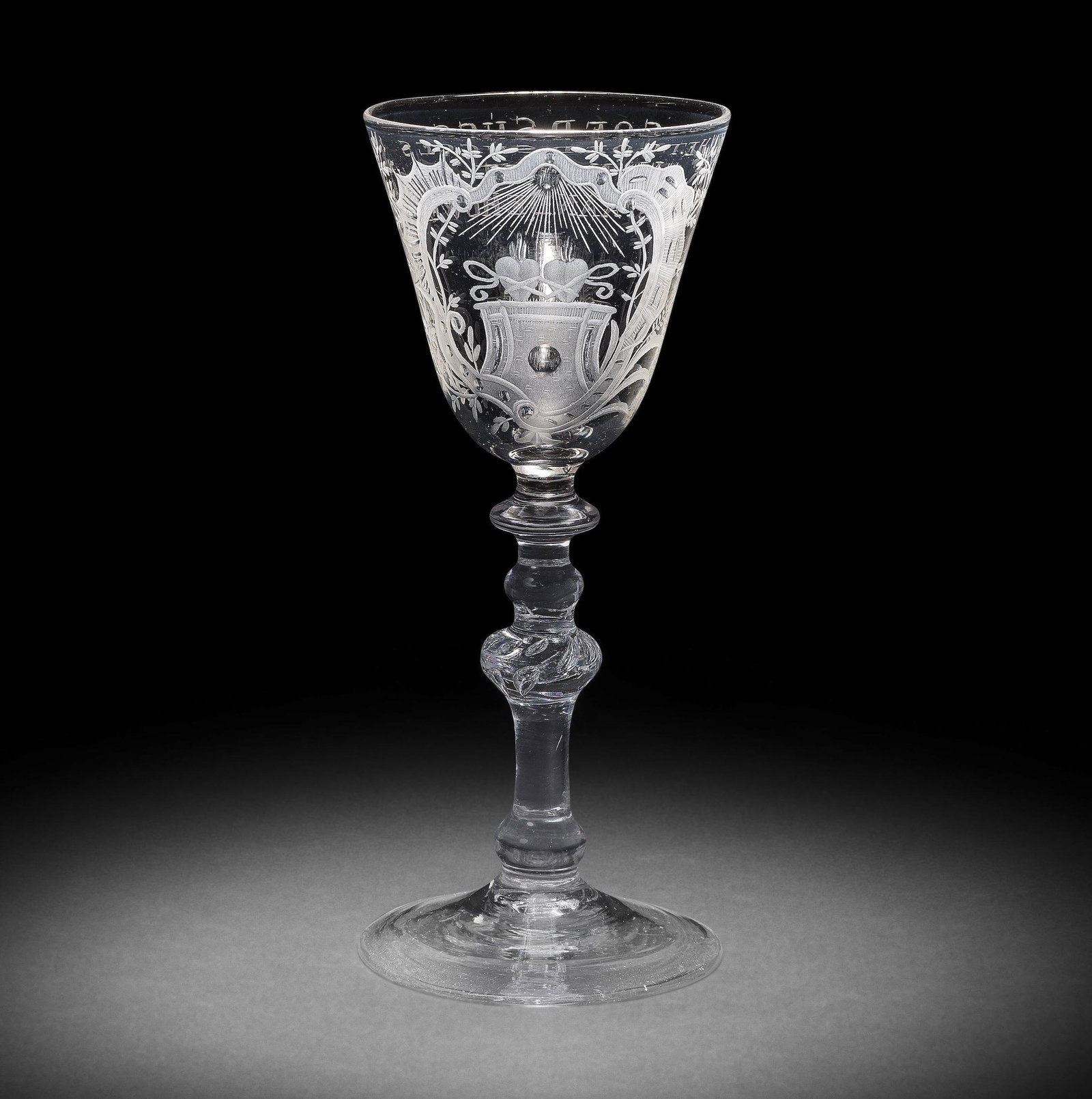 A good Dutch engraved light baluster marriage wine glass, circa 1760: A good Dutch engraved light baluster marriage wine glass, circa 1760 The generous round funnel bowl decorated with two flaming hearts tied by ribbons upon a pedestal, beneath a radiant sun, within a r