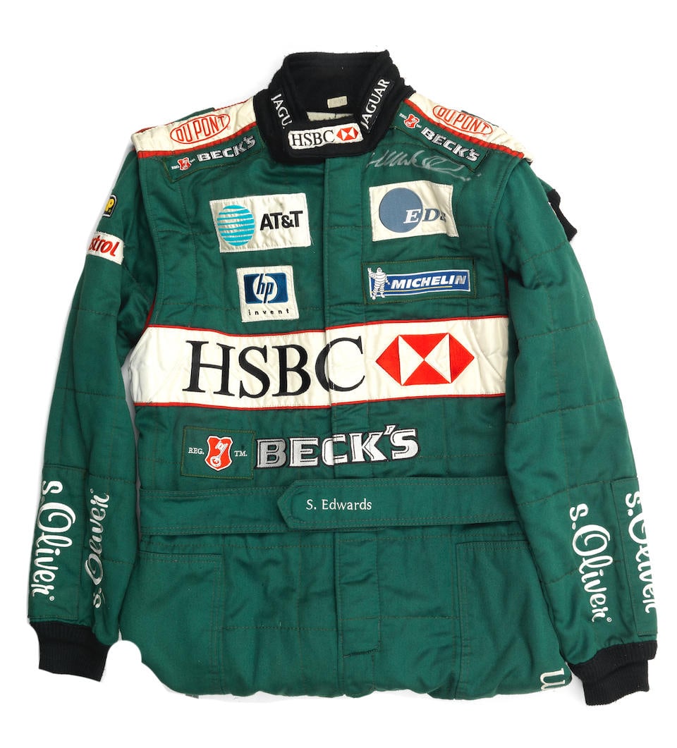A signed pair of Jaguar F1 mechanics' overalls, by OMP,: A signed pair of Jaguar F1 mechanics' overalls, by OMP, green overalls, with sponsors logos, signed by Mark Webber to left chest in silver. Lot to be sold without reserve. For further information on t