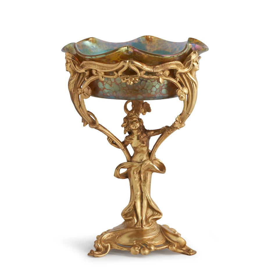 LOETZ OIL SPOT GLASS AND GILT METAL FIGURAL COMPOTE Czech Republic, c. 1900, unmarked, ht. 11 3/...: LOETZ OIL SPOT GLASS AND GILT METAL FIGURAL COMPOTE Czech Republic, c. 1900, unmarked, ht. 11 3/4, approx. dia. 8 1/4 in. Footnotes: Provenance: Valerio, Miami, Florida. For further information on thi