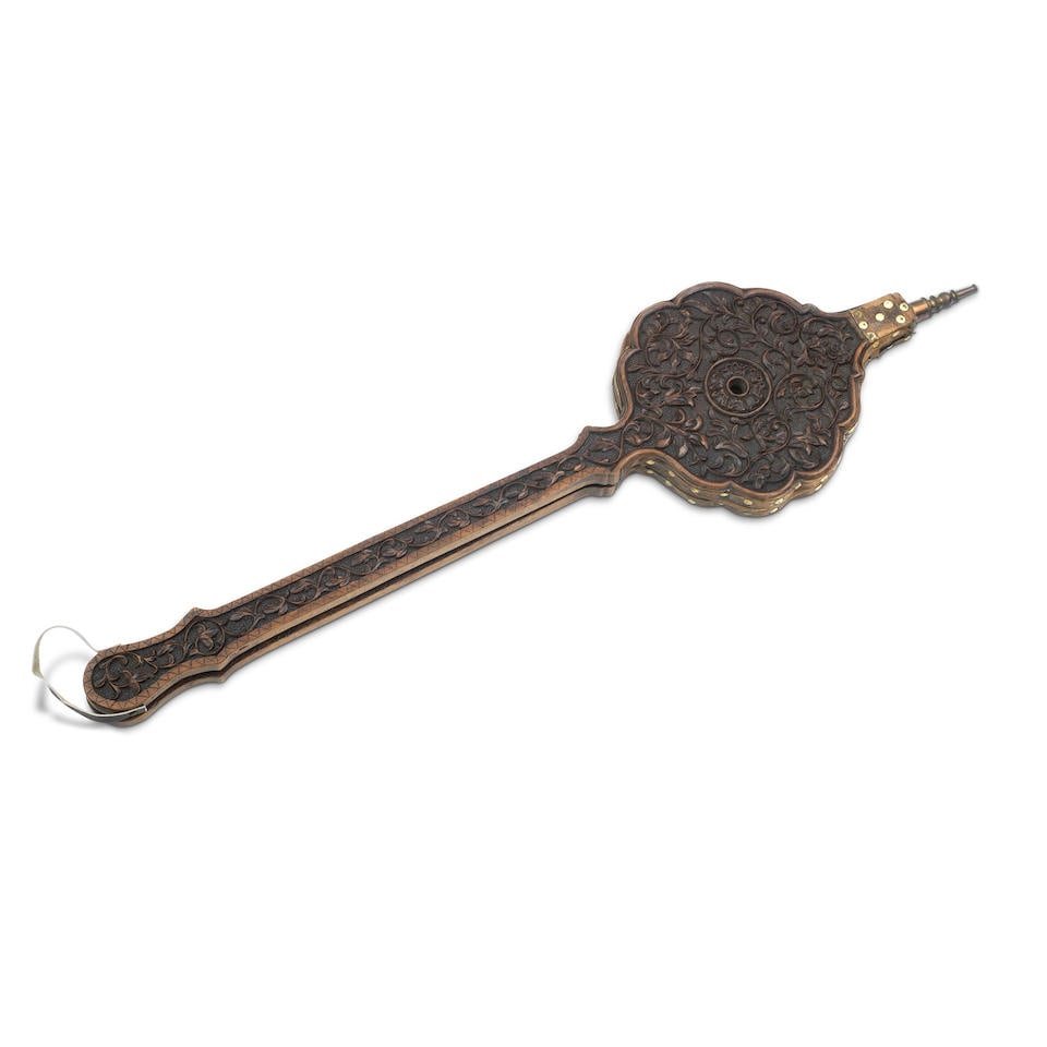 A pair of beech parlour bellows Probably German, 19th century: A pair of beech parlour bellows Probably German, 19th century Carved in relief with scrolling foliage around a central rosette, with extended handle, 109cm long, 42.5cm wide. For further information o