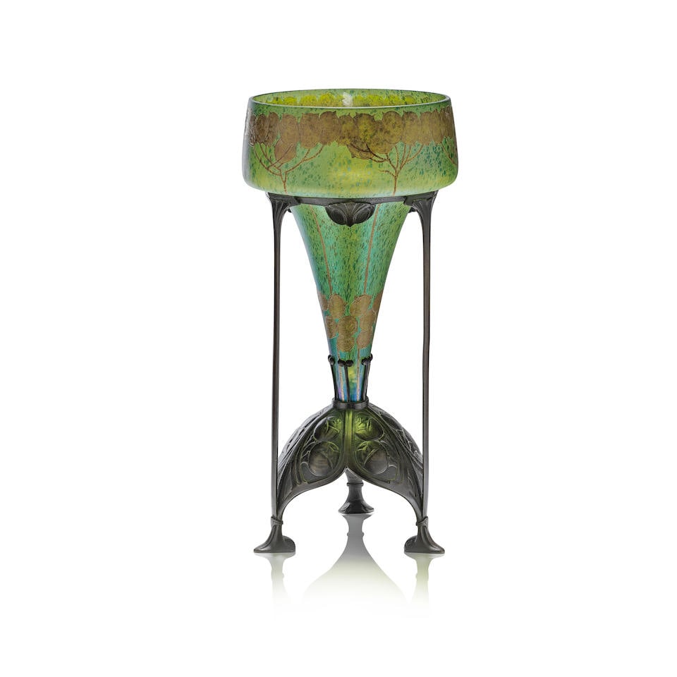 Loetz 'Papillon' vase, circa 1900: Loetz 'Papillon' vase, circa 1900 Green glass with speckled iridescent overlay, decorated with raised gilt of thistles, raised on a patinated bronze tripod support embossed with stylised floral decora