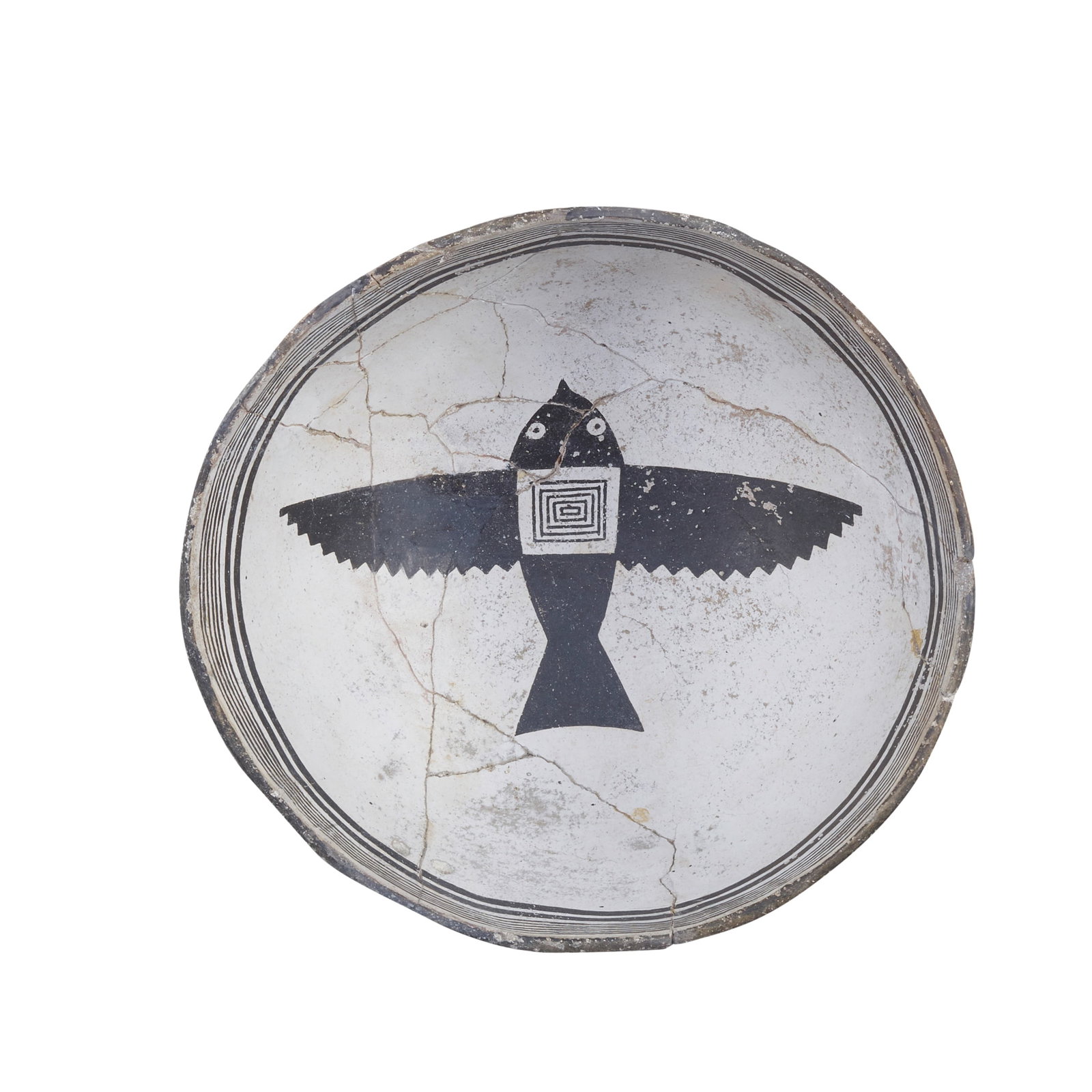A Mimbres black-on-white pictorial bowl: A Mimbres black-on-white pictorial bowl Designed with a banded interior rim centering a bird in flight with concentric rectangles adorning the center of the body, reassembled. height 4in, diameter 8 1