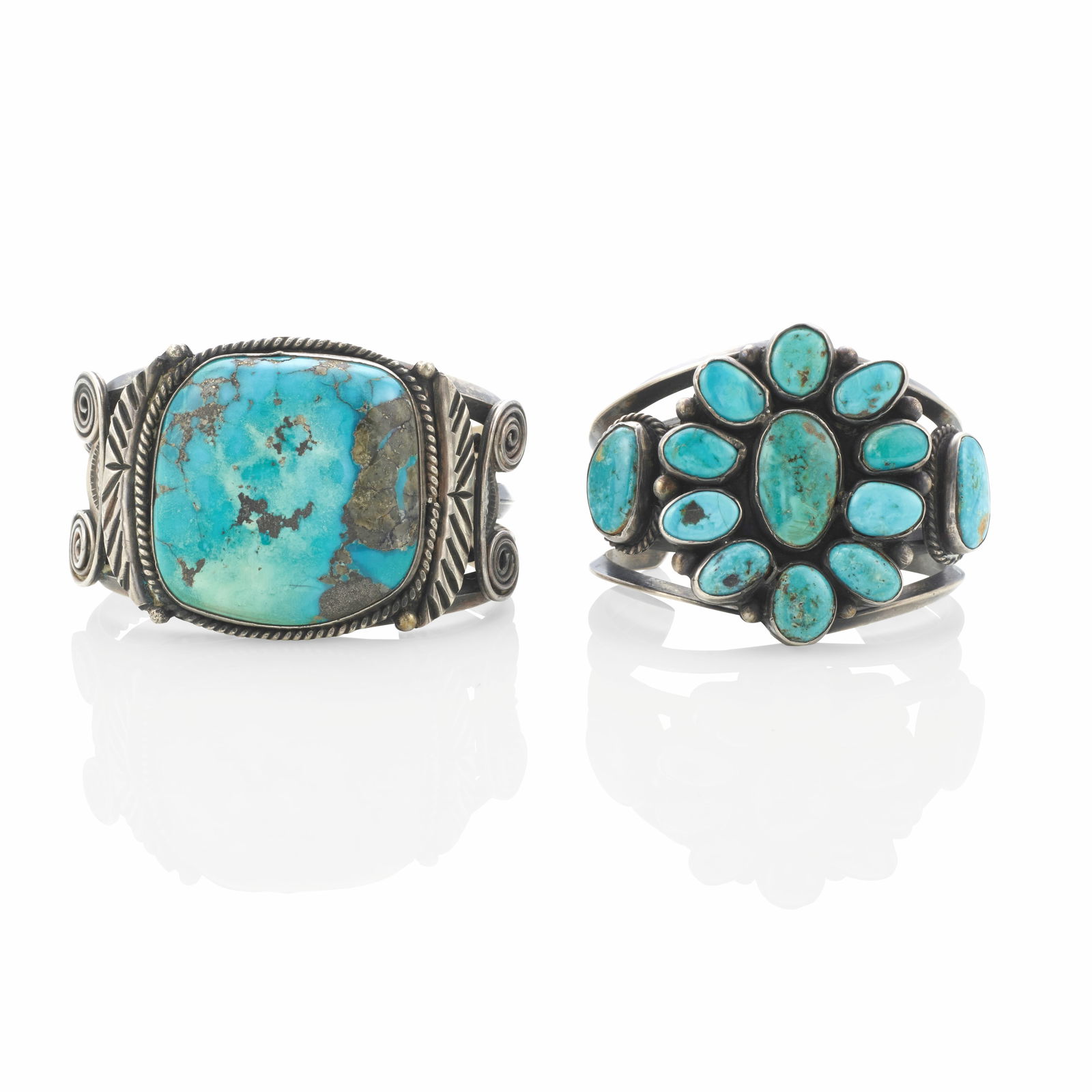 Two Diné (Navajo) cuff bracelets: Two Diné (Navajo) cuff bracelets The first constructed of twisted and carinated wires supporting a large turquoise stone flanked by wire accents; the second with a cluster of oval turquoise raise