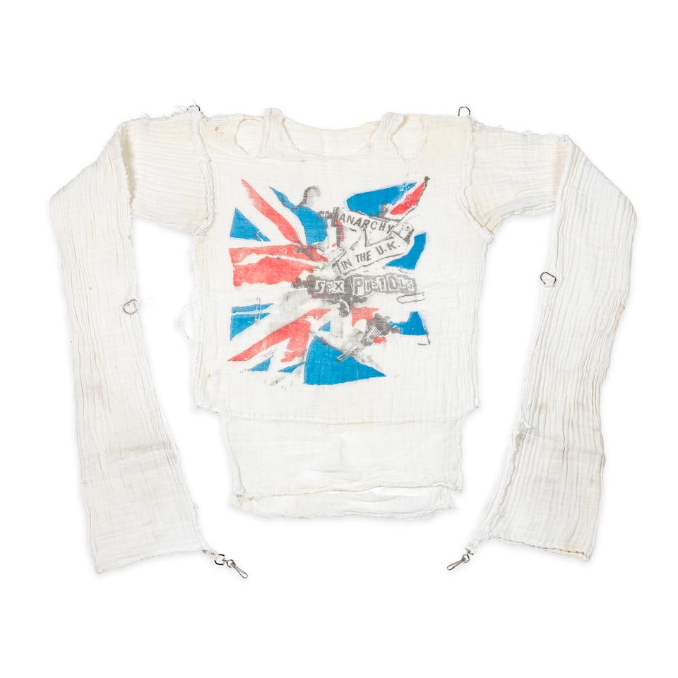 Vivienne Westwood & Malcolm McLaren A Seditionaries Jamie Reid Anarchy In The UK Muslin Shirt, 1978: Vivienne Westwood & Malcolm McLaren A Seditionaries Jamie Reid Anarchy In The UK Muslin Shirt, 1978 printed in red, blue and black on white muslin, unlabelled, with D ring to each shoulder and D ring