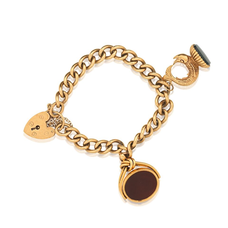 CHARM BRACELET: CHARM BRACELET 9 carat gold curb link bracelet Suspending two charms, a hardstone stylised fish seal and a hardstone and bloodstone swivel fob charm UK hallmarks Inner circumference approx. 15.0cm Wei