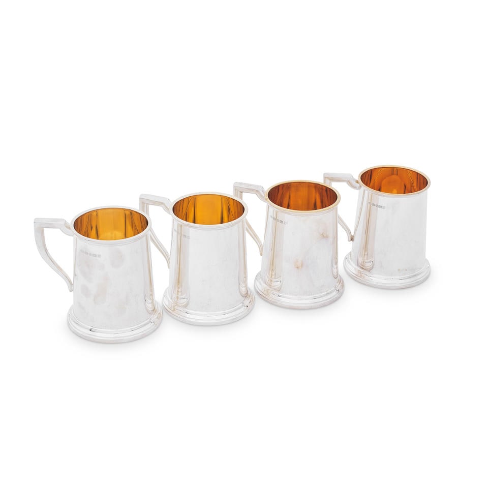 A set of four modern silver small mugs Mappin & Webb, Sheffield 2008 (4): A set of four modern silver small mugs Mappin & Webb, Sheffield 2008 Plain slightly tapering cylindrical form with polished sides and skirted foot, gilt interiors, height 9.5cm, weight 26.6oz. (4) For