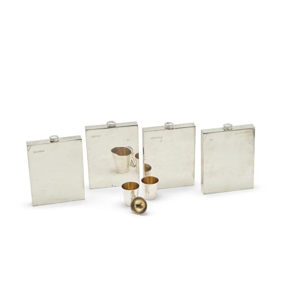 A cased travelling electroplated drinking flask set James Dixon & Son: A cased travelling electroplated drinking flask set James Dixon & Son The attaché style case fitted with four large electroplated flasks, plain rectangular form, with screw fitting caps, top cor